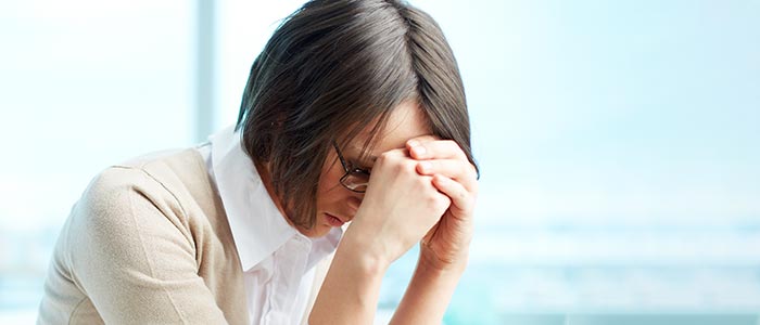 lady holding her head with headache