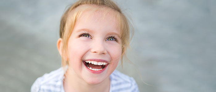 little girl smiling in front of the camera