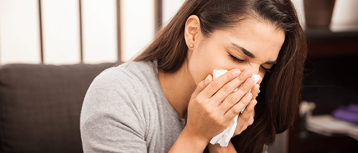 lady using tissue on her stuffy nose